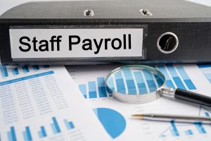 An image showing a small business owner talking to an accountant for payroll services for small businesses
